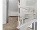 Bright stairway featuring white railing, carpeted steps, and a landing area with soft carpeting at 538 Kristin Ln, Henderson, NV 89011