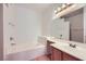 Bathroom featuring a soaking tub, vanity with sink, and a large mirror at 5650 E Sahara Ave # 1001, Las Vegas, NV 89142