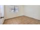 Simple bedroom showcasing neutral walls, tiled flooring, and natural light at 5650 E Sahara Ave # 1001, Las Vegas, NV 89142
