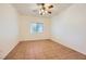 A bedroom with tiled floors, neutral walls, and a ceiling fan at 5650 E Sahara Ave # 1001, Las Vegas, NV 89142