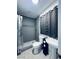 Modern bathroom with tiled shower, sleek fixtures, and a pedestal sink at 5821 Marka Dr, Las Vegas, NV 89108
