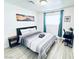 Cozy bedroom features a desk, artwork, and plenty of natural light at 5821 Marka Dr, Las Vegas, NV 89108