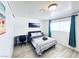 Neutral bedroom features a desk, artwork, and plenty of natural light at 5821 Marka Dr, Las Vegas, NV 89108