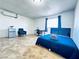 Cozy bedroom featuring a comfortable bed, mini-fridge, and a dedicated workspace at 5821 Marka Dr, Las Vegas, NV 89108