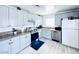 Updated kitchen with stainless steel appliances, granite counters, and blue cabinets at 5821 Marka Dr, Las Vegas, NV 89108