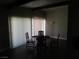 Neutral dining room with vertical blinds and wood flooring at 6409 Burgundy Way, Las Vegas, NV 89107