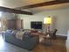 Cozy living room with a brick fireplace, comfortable seating, and modern flooring at 6409 Burgundy Way, Las Vegas, NV 89107