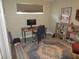 Functional home office space with a desk, bookshelf, neutral wall color, and a decorative rug at 6409 Burgundy Way, Las Vegas, NV 89107