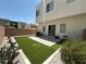 Low-maintenance backyard featuring artificial turf, patio, and a fully fenced in yard at 6450 Cinnamon Hazlenut St, North Las Vegas, NV 89084