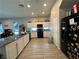 Bright, open kitchen area with stainless steel appliances, granite countertops and white cabinetry at 6450 Cinnamon Hazlenut St, North Las Vegas, NV 89084