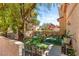 Cozy back patio features an outdoor dining area and lush landscaping, perfect for relaxation and entertaining at 68 Belle Soleil Ave, Las Vegas, NV 89123