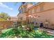 A cozy patio with seating and greenery provides a relaxing backyard retreat at 68 Belle Soleil Ave, Las Vegas, NV 89123