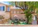 Backyard with artificial turf, patio furniture, and a charming desert landscape at 68 Belle Soleil Ave, Las Vegas, NV 89123