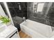 A soaking tub in a stylish bathroom is tiled with marble and has sleek white fixtures at 68 Belle Soleil Ave, Las Vegas, NV 89123