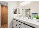 Bright bathroom with double sink vanity, white cabinets, and wooden storage at 68 Belle Soleil Ave, Las Vegas, NV 89123