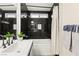 Modern bathroom featuring black marble tile shower and tub with white cabinets at 68 Belle Soleil Ave, Las Vegas, NV 89123