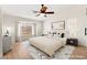 Staged bedroom with a ceiling fan, bright windows, and modern decor at 68 Belle Soleil Ave, Las Vegas, NV 89123
