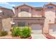 Charming two-story townhome with an attached garage and well-maintained landscaping at 68 Belle Soleil Ave, Las Vegas, NV 89123