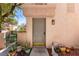 Inviting front entry with well-maintained door and charming potted plants, creating a welcoming first impression at 68 Belle Soleil Ave, Las Vegas, NV 89123