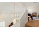 Bright hallway with wood floors, hanging lights, and staircase at 68 Belle Soleil Ave, Las Vegas, NV 89123