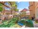 Relaxing patio with outdoor seating, plants, and a tan sun umbrella at 68 Belle Soleil Ave, Las Vegas, NV 89123