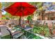 Cozy patio area with outdoor seating and decor, shaded by a red umbrella at 68 Belle Soleil Ave, Las Vegas, NV 89123