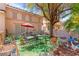 Relaxing patio area with outdoor seating, decor, and a red umbrella at 68 Belle Soleil Ave, Las Vegas, NV 89123