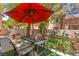 Cozy patio area with outdoor seating and decor, shaded by a red umbrella at 68 Belle Soleil Ave, Las Vegas, NV 89123