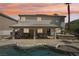 Outdoor living space features an in-ground pool and spa, and a covered patio with an outdoor kitchen at 691 Vineland Ave, Henderson, NV 89052