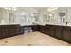 Bathroom featuring dual sink vanities, large mirrors, and tile floors at 691 Vineland Ave, Henderson, NV 89052