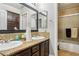 Bathroom boasts double sinks, granite countertops, and a shower with glass doors at 691 Vineland Ave, Henderson, NV 89052