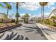Gated community entrance featuring lush landscaping, palm trees, and secure access for residents at 691 Vineland Ave, Henderson, NV 89052