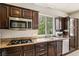 This charming kitchen features granite counters, stainless appliances and ample cabinet space at 691 Vineland Ave, Henderson, NV 89052