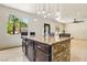 Kitchen island featuring granite countertop and stone accents, complemented by modern pendant lighting at 691 Vineland Ave, Henderson, NV 89052