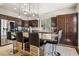Stylish kitchen boasts dark wood cabinets, stainless steel appliances, and a large island with bar seating at 691 Vineland Ave, Henderson, NV 89052