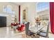 Bright and airy living room with soaring ceilings, grand windows, and a stunning stone fireplace at 691 Vineland Ave, Henderson, NV 89052