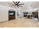 Spacious open-concept living room with tile flooring, ceiling fan, and seamless flow into the kitchen area at 691 Vineland Ave, Henderson, NV 89052