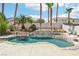 Backyard pool features a rock waterfall and mature palm trees, creating a backyard paradise at 691 Vineland Ave, Henderson, NV 89052