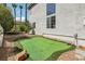 Lush backyard with personal putting green, palm trees, and rock landscaping at 691 Vineland Ave, Henderson, NV 89052