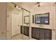 Bathroom featuring dual sink vanity with decorative mirrors and modern lighting at 722 Barrie Ct, Henderson, NV 89002