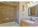 Bathroom featuring a granite countertop, a decorative mirror, and a tiled shower at 722 Barrie Ct, Henderson, NV 89002