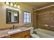 Bathroom featuring a granite countertop, a decorative mirror, and a tiled shower at 722 Barrie Ct, Henderson, NV 89002