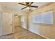 Bright bedroom with wood floors, closet with mirrored doors, ceiling fan, and natural light at 722 Barrie Ct, Henderson, NV 89002