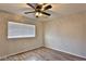 Minimalist bedroom featuring wood floors, a ceiling fan, and a window with blinds at 722 Barrie Ct, Henderson, NV 89002