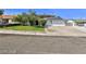 Charming single-story home with a well-manicured lawn, mature trees, and a two-car garage at 722 Barrie Ct, Henderson, NV 89002