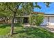 Welcoming home featuring mature trees, a lush lawn, and a charming front entry with a tiled roof at 722 Barrie Ct, Henderson, NV 89002