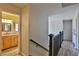 Upstairs hallway featuring wood floors and a view into a bathroom at 722 Barrie Ct, Henderson, NV 89002