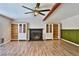 Living room showcasing a fireplace, wood flooring, and custom built-in shelving at 722 Barrie Ct, Henderson, NV 89002