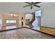 Spacious living room featuring laminate flooring, a ceiling fan, and a staircase to the upper level at 722 Barrie Ct, Henderson, NV 89002