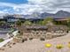 Scenic entrance with a stone 'Sandalwood' sign, lush greenery, and mountain views in the background at 787 Willits St, Las Vegas, NV 89138